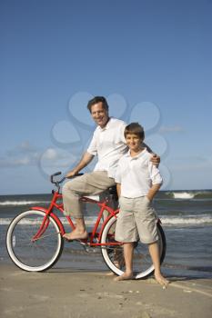 Royalty Free Photo of a Father Riding a Bike With His Son
