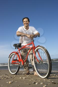 Royalty Free Photo of a Man Leaning Against a Red Bike