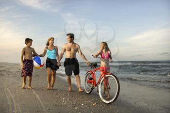 Royalty Free Photo of a Family Walking on the Beach