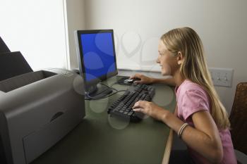 Royalty Free Photo of a Preteen Girl Using a Computer