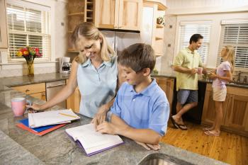 Royalty Free Photo of a Family in the Kitchen Doing Homework and Chatting