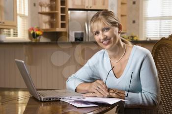 Royalty Free Photo of a Woman Paying Bills on a Laptop Computer