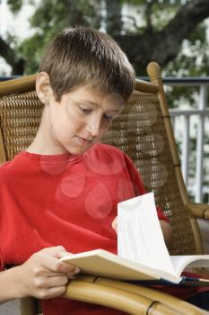Royalty Free Photo of a Preteen Boy Reading a Book