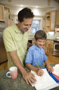 Royalty Free Photo of a Father Helping His Son With Homework