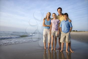 Royalty Free Photo of a Family Smiling on a Beach