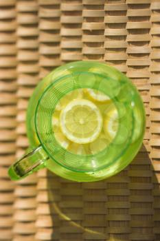 Royalty Free Photo of an Overview of a Green Plastic Pitcher of Lemonade With Sliced Lemons