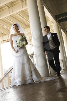 Royalty Free Photo of a Bride and Groom Standing on a Porch