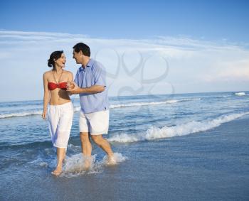 Royalty Free Photo of a Couple Holding Hands Walking on a Beach