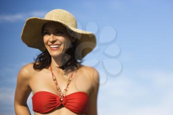 Royalty Free Photo of a Woman Wearing a Straw Hat Smiling