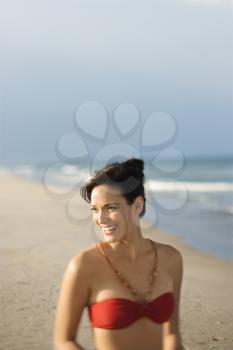 Royalty Free Photo of a Woman Smiling on a Beach in a Swimsuit