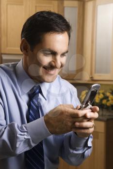 Royalty Free Photo of a Man Holding a Cellphone and Smiling