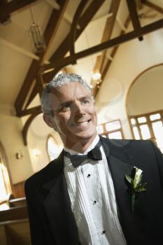 Royalty Free Photo of a Smiling Groom Inside a Church