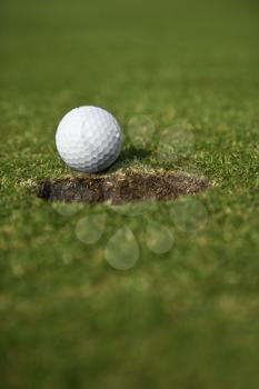 Royalty Free Photo of a Golf Ball Close to the Hole