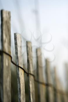 Royalty Free Photo of a Wooden Fence With Rusted Wiring