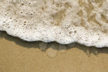 Royalty Free Photo of a Close-up of Sand and Wave