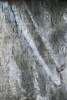 Royalty Free Photo of a Close-up of a Script Engraved into a Stone at the Roman Forum in Rome, Italy