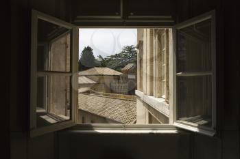 Royalty Free Photo of an Open Window with view of rooftops in the Vatican Museum, Rome, Italy.