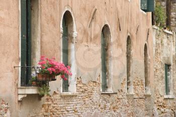 Royalty Free Photo of Arched Windows and Geranium Flowers in Venice, Italy