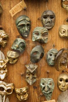 Royalty Free Photo of a Group of Theatrical Masks Hanging on a Wooden Wall