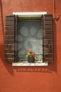 Royalty Free Photo of Potted Red Geraniums on a Window Sill