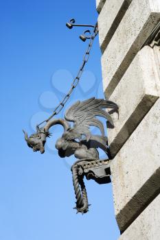 Royalty Free Photo of a Winged Gargoyle Chained to a Wall