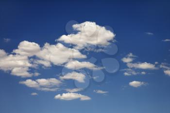 White puffy clouds in blue sky.
