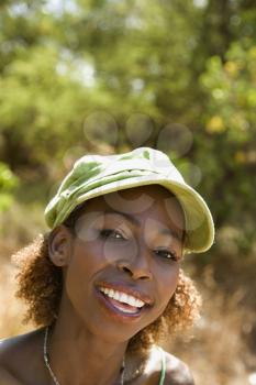 MId-adult African American female wearing cap and making eye contact.