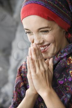 Royalty Free Photo of a Smiling Woman With Hands Together in Prayer Position