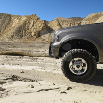 Four wheel drive truck in desert landscape in Death Valley National Park.