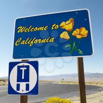 Royalty Free Photo of Welcome to California Sign With a Strip of Highway