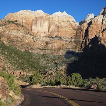 Royalty Free Photo of a Two Lane Road Winding Through Rocky Desert Cliffs in Zion National Park, Utah
