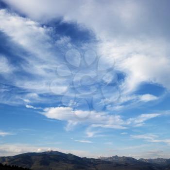 Royalty Free Photo of Clouds With a Mountain Range in the Distance
