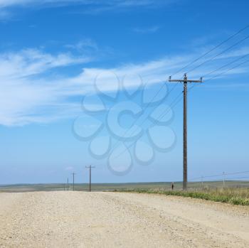 Royalty Free Photo of Power Lines Alongside a dirt Road in Rural South Dakota