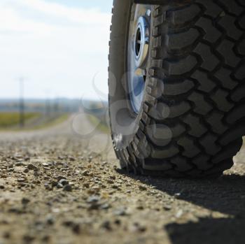 Royalty Free Photo of a Big Truck Tire on a Gravel Road in Rural South Dakota