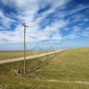 Royalty Free Photo of Power Lines Alongside a Dirt Road in Rural South Dakota