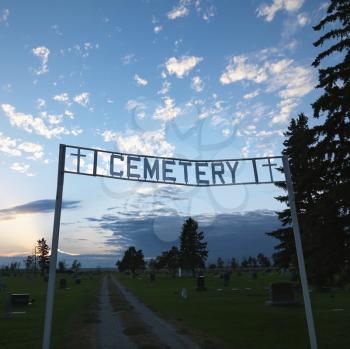 Royalty Free Photo of a Sign Over the Entrance to a Cemetery at Dusk in Rural South Dakota