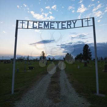 Royalty Free Photo of a Sign Over the Entrance to a Cemetery at Dusk in Rural South Dakota