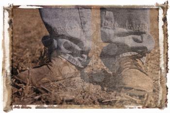 Royalty Free Photo of a Polaroid Transfer of Feet Shot of Man Wearing Work Boots Standing in Soybean Field