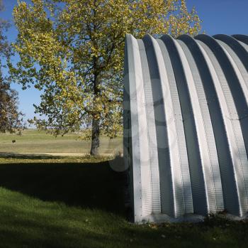 Royalty Free Photo of a Side View of a Steel Hay Storage Building on a Farm
