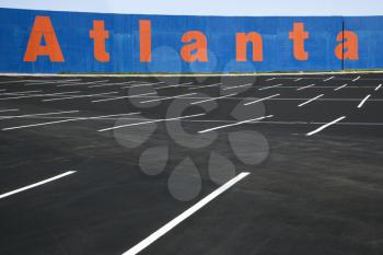 Royalty Free Photo of an Empty Parking Lot With Atlanta Painted on a Wall in Atlanta, Georgia