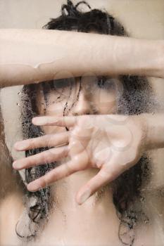 Royalty Free Photo of a Pretty Young Woman Wet in the Shower Leaning Against the Glass