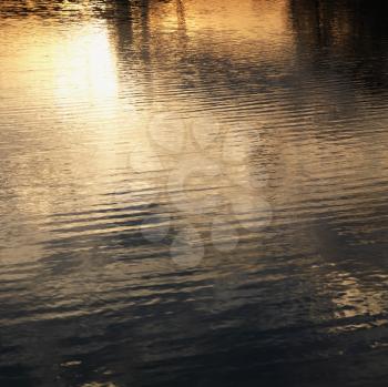 Royalty Free Photo of Reflections of Orange and Yellow Sunset on Water