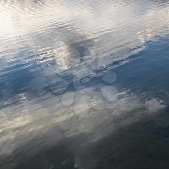 Royalty Free Photo of Reflections of Cloud Formations on Rippling Water