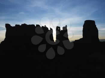 Royalty Free Photo of Sandstone Mesas and Buttes Silhouetted in Monument Valley