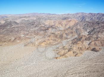 Royalty Free Photo of an Aerial of a Desert With Mountain Range in the Background