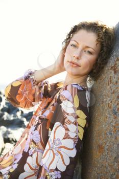 Royalty Free Photo of a Woman Leaning Against a Rock