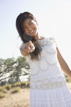 Royalty Free Photo of a Young Female Smiling and Pointing