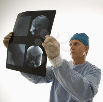 Royalty Free Photo of a Doctor Examining an X-Ray