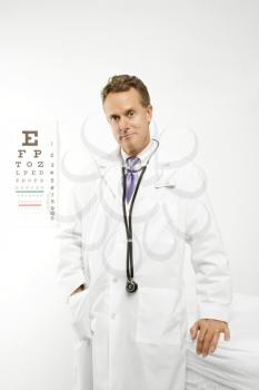 Royalty Free Photo of a Doctor Holding With an Eye Chart in the Background