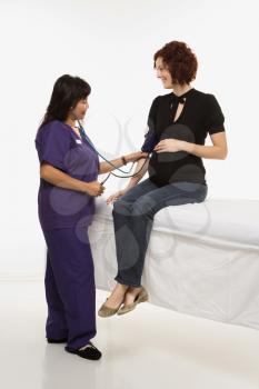 Royalty Free Photo of a Pregnant Woman Having Her Vital Signs Checked By a Nurse